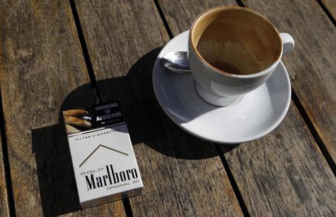 A Marlboro cigarettes pack, a brand of Philip Morris Tobacco, lies next to an empty coffee cup at a cafe in central Sydney June 27, 2011. RE A Marlboro cigarettes pack, a brand of Philip Morris Tobacco, lies next to an empty coffee cup at a cafe in central Sydney June 27, 2011. RE