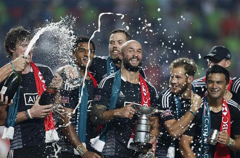 New Zealand captain D J Forbes holds the trophy as he celebrates with his teammates after beating England in the Cup final of the Hong Kong New Zealand captain D J Forbes holds the trophy as he celebrates with his teammates after beating England in the Cup final of the Hong Kong