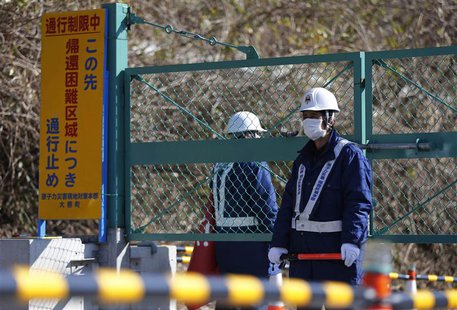 Security personnel stand guard near a steel gate that marks the border between Tamura and Okuma town in Okuma town, Fukushima prefecture Apr Security personnel stand guard near a steel gate that marks the border between Tamura and Okuma town in Okuma town, Fukushima prefecture Apr