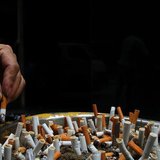 A man discards a cigarette butt outside a construction site in Central, a business district in Hong Kong, October 18, 2006. REUTERS/Paul Yeu A man discards a cigarette butt outside a construction site in Central, a business district in Hong Kong, October 18, 2006. REUTERS/Paul Yeu