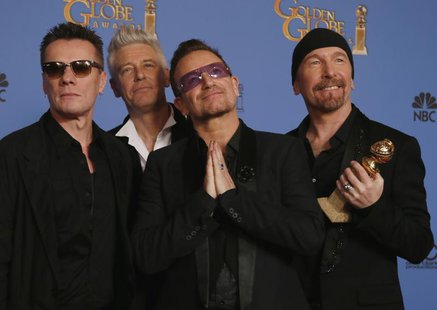 Adam Clayton, Bono, Larry Mullen, Jr., and The Edge (L to R), from the band U2, pose backstage with their award for Best Original Song for " Adam Clayton, Bono, Larry Mullen, Jr., and The Edge (L to R), from the band U2, pose backstage with their award for Best Original Song for "