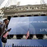 A woman walks past a banner with the logo of Juniper Networks Inc. covering the facade of the New York Stock Exchange, October 29, 2009. REU A woman walks past a banner with the logo of Juniper Networks Inc. covering the facade of the New York Stock Exchange, October 29, 2009. REU