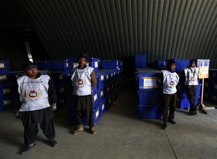 Afghan election commission stand by before preparing to send ballot boxes and election material to polling stations at a warehouse in Kabul Afghan election commission stand by before preparing to send ballot boxes and election material to polling stations at a warehouse in Kabul