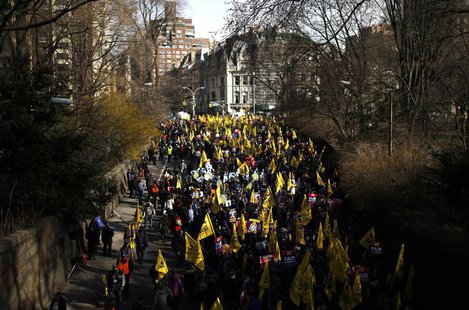 Members of the Service Employees International Union (SEIU) march out of Central Park onto 5th Avenue during a protest in support of a new c Members of the Service Employees International Union (SEIU) march out of Central Park onto 5th Avenue during a protest in support of a new c