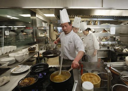 Chiefs cook a meal at a restaurant inside a shopping mall in a wealthy district in Beijing February 25, 2013. REUTERS/Kim Kyung-Hoon Chiefs cook a meal at a restaurant inside a shopping mall in a wealthy district in Beijing February 25, 2013. REUTERS/Kim Kyung-Hoon