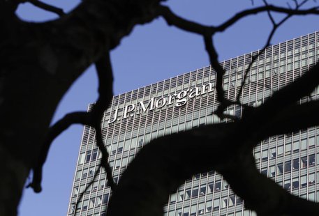 A sign on the Canary Wharf offices of JP Morgan is seen through the branches of a tree in London January 28, 2014. REUTERS/Simon Newman A sign on the Canary Wharf offices of JP Morgan is seen through the branches of a tree in London January 28, 2014. REUTERS/Simon Newman