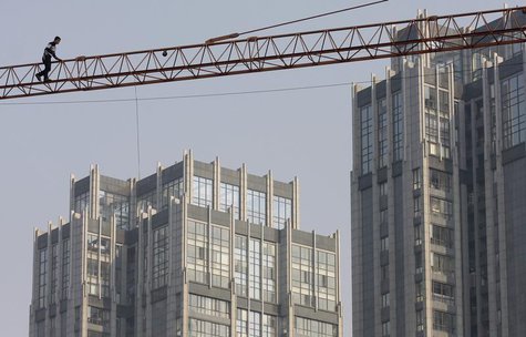 A labourer walks on a crane at a construction site in Nanjing, Jiangsu province December 14, 2011. REUTERS/Sean Yong A labourer walks on a crane at a construction site in Nanjing, Jiangsu province December 14, 2011. REUTERS/Sean Yong