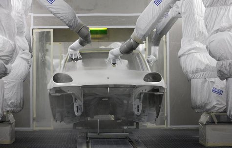 Robot arms coat a Porsche Macan at the new plant in the eastern German city of Leipzig February 5, 2014. REUTERS/Tobias Schwarz Robot arms coat a Porsche Macan at the new plant in the eastern German city of Leipzig February 5, 2014. REUTERS/Tobias Schwarz