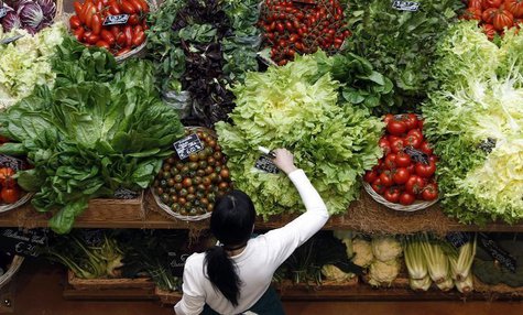 An employee arranges pricetags at a vegetables work bench during the opening day of upmarket Italian food hall chain Eataly's flagship store An employee arranges pricetags at a vegetables work bench during the opening day of upmarket Italian food hall chain Eataly's flagship store
