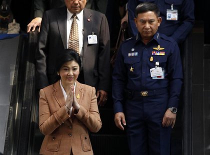 Thailand's Prime Minister Yingluck Shinawatra gestures as she leaves the Royal Thai Air Force Headquarters, after a defense meeting in Bangk Thailand's Prime Minister Yingluck Shinawatra gestures as she leaves the Royal Thai Air Force Headquarters, after a defense meeting in Bangk