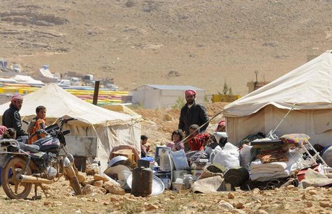 Refugees who fled the violence from the Syrian town of Flita, near Yabroud, stand outside their tents at the border town of Arsal, in the ea Refugees who fled the violence from the Syrian town of Flita, near Yabroud, stand outside their tents at the border town of Arsal, in the ea