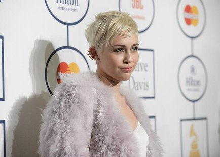 Singer Miley Cyrus attends the Clive Davis Pre-Grammy Gala and Salute to Industry Icons, honoring Universal Music Group Chairman and CEO Luc Singer Miley Cyrus attends the Clive Davis Pre-Grammy Gala and Salute to Industry Icons, honoring Universal Music Group Chairman and CEO Luc