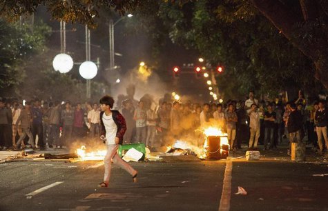 Demonstrators set fire to trash cans, as they protest against a chemical plant project, on a street in Maoming, Guangdong province, early Ap Demonstrators set fire to trash cans, as they protest against a chemical plant project, on a street in Maoming, Guangdong province, early Ap