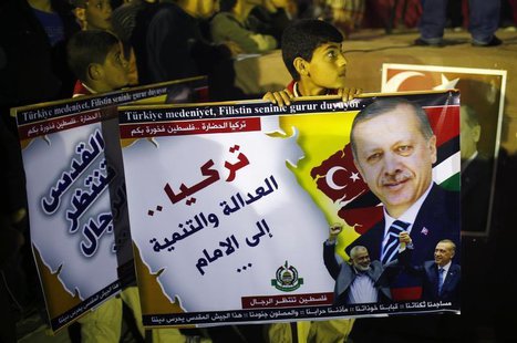 A Palestinian boy holds a poster of Turkish Prime Minister Tayyip Erdogan as he celebrates after Erdogan declared victory in local polls dur A Palestinian boy holds a poster of Turkish Prime Minister Tayyip Erdogan as he celebrates after Erdogan declared victory in local polls dur
