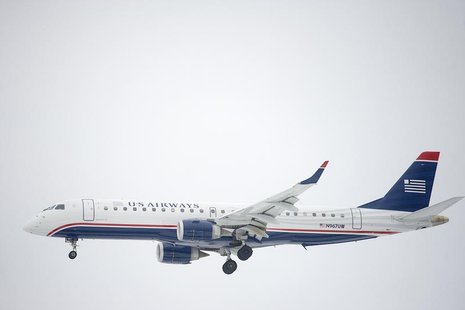 A US Airways Embraer ERJ-190 jet descends for landing at Philadelphia International Airport in Philadelphia, Pennsylvania on December 9, 201 A US Airways Embraer ERJ-190 jet descends for landing at Philadelphia International Airport in Philadelphia, Pennsylvania on December 9, 201