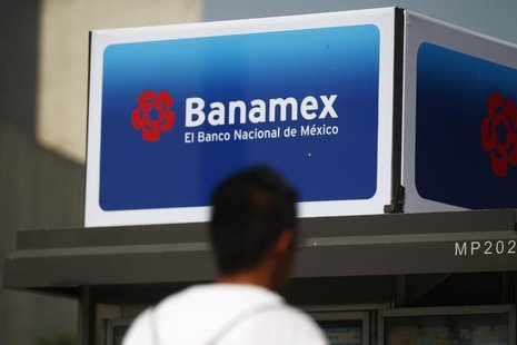 A man walks in front of a Banamex advertisement in Mexico City February 28, 2014. REUTERS/Edgard Garrido A man walks in front of a Banamex advertisement in Mexico City February 28, 2014. REUTERS/Edgard Garrido