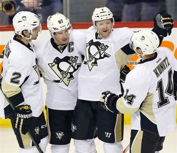 Apr 3, 2014; Winnipeg, Manitoba, CAN; Pittsburgh Penguins defenseman Paul Martin (7) celebrates with teammates after scoring a goal during t Apr 3, 2014; Winnipeg, Manitoba, CAN; Pittsburgh Penguins defenseman Paul Martin (7) celebrates with teammates after scoring a goal during t