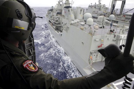 Leading Seaman Aircrewman Joel Young looks out from Tiger75, an S-70B-2 Seahawk helicopter, after it launched from the Australian Navy ship Leading Seaman Aircrewman Joel Young looks out from Tiger75, an S-70B-2 Seahawk helicopter, after it launched from the Australian Navy ship