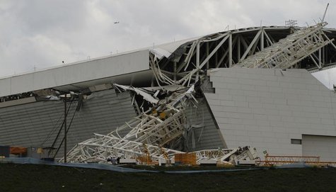 Workers stand near a crane that collapsed on the site of the Arena Sao Paulo stadium, known as "Itaquerao", which will host the opening socc Workers stand near a crane that collapsed on the site of the Arena Sao Paulo stadium, known as "Itaquerao", which will host the opening socc