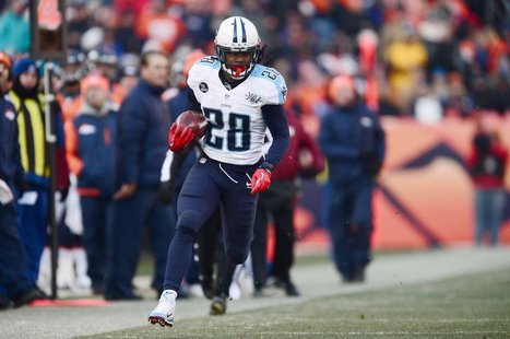Dec 8, 2013; Denver, CO, USA; Tennessee Titans running back Chris Johnson (28) rushes on fourth down in the second quarter against the Denve Dec 8, 2013; Denver, CO, USA; Tennessee Titans running back Chris Johnson (28) rushes on fourth down in the second quarter against the Denve