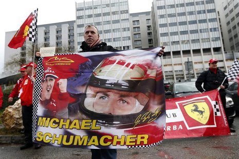 Philippe, a fan from Lyon, waves a flag as he attends a silent 45th birthday tribute to seven-times former Formula One world champion Michae Philippe, a fan from Lyon, waves a flag as he attends a silent 45th birthday tribute to seven-times former Formula One world champion Michae