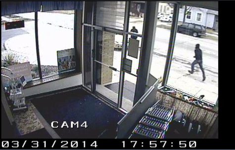 A surveillance picture of the Aurora Pharmacy purse snatching suspect prior to committing the crime March 31, 2014. A surveillance picture of the Aurora Pharmacy purse snatching suspect prior to committing the crime March 31, 2014.