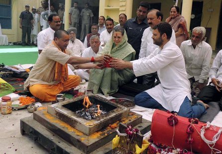 Chief of India's ruling Congress party Sonia Gandhi (C) and her son and Vice President of Congress Rahul Gandhi (front R) perform a religiou Chief of India's ruling Congress party Sonia Gandhi (C) and her son and Vice President of Congress Rahul Gandhi (front R) perform a religiou