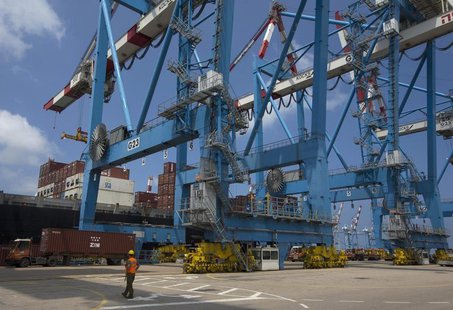 A worker walks near cranes unloading containers from a ship at the port of the northern city of Haifa April 23, 2013. REUTERS/Ronen Zvulun A worker walks near cranes unloading containers from a ship at the port of the northern city of Haifa April 23, 2013. REUTERS/Ronen Zvulun