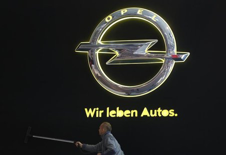 A worker cleans a wall at the Opel stand during a press presentation prior to the Essen Motor Show in Essen November 27, 2013. REUTERS/Ina F A worker cleans a wall at the Opel stand during a press presentation prior to the Essen Motor Show in Essen November 27, 2013. REUTERS/Ina F