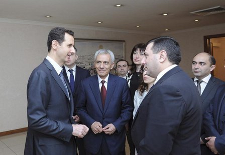 Syria's President Bashar al-Assad (L) meets with an Armenian parliamentary delegation in Damascus March 27, 2014, in this handout released b Syria's President Bashar al-Assad (L) meets with an Armenian parliamentary delegation in Damascus March 27, 2014, in this handout released b