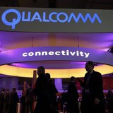 Visitors walk past the Qualcomm stand at the Mobile World Congress in Barcelona, February 24, 2014. REUTERS/Albert Gea Visitors walk past the Qualcomm stand at the Mobile World Congress in Barcelona, February 24, 2014. REUTERS/Albert Gea