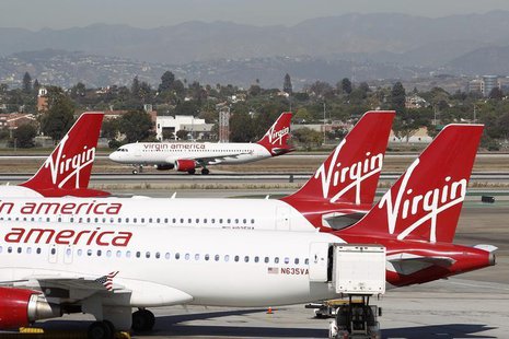 A Virgin America jet takes off past other aircraft parked at Terminal 3 as the terminal begins to reopen the day after a shooting incident o A Virgin America jet takes off past other aircraft parked at Terminal 3 as the terminal begins to reopen the day after a shooting incident o