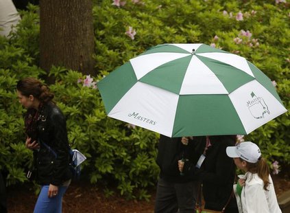 Patrons leave after play was suspended and the course closed due to inclement weather during a practice round ahead of the Masters golf tour Patrons leave after play was suspended and the course closed due to inclement weather during a practice round ahead of the Masters golf tour