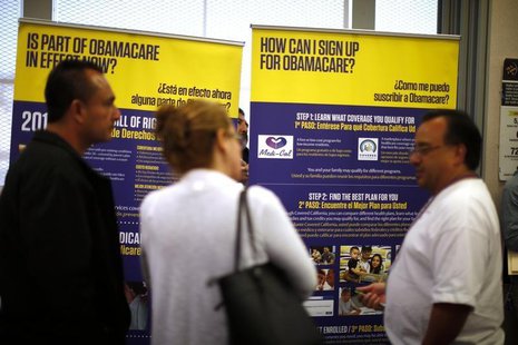 Julian Gomez (R) explains Obamacare to people at a health insurance enrolment event in Commerce, California March 31, 2014. REUTERS/Lucy Nic Julian Gomez (R) explains Obamacare to people at a health insurance enrolment event in Commerce, California March 31, 2014. REUTERS/Lucy Nic