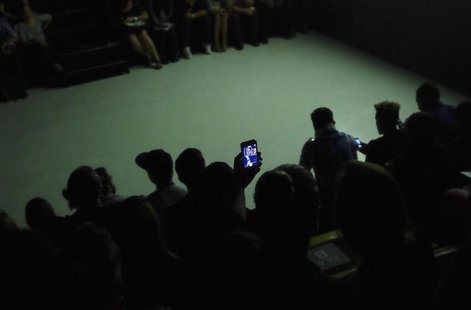 Visitors take a "selfie" with a mobile phone near the runway during Sao Paulo Fashion Week April 4, 2014. REUTERS/Nacho Doce Visitors take a "selfie" with a mobile phone near the runway during Sao Paulo Fashion Week April 4, 2014. REUTERS/Nacho Doce