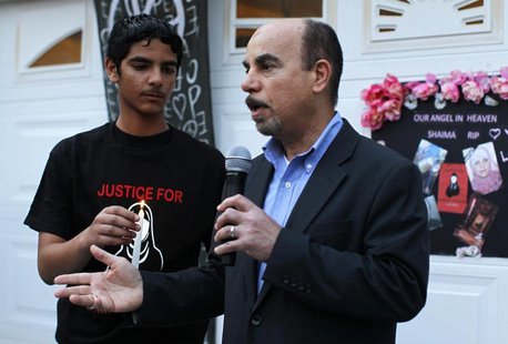 Kassim Alhimidi (R) speaks next to his son Mohammed Alhimidi (L) during a candlelight vigil to remember his wife Shaima Alawadi outside thei Kassim Alhimidi (R) speaks next to his son Mohammed Alhimidi (L) during a candlelight vigil to remember his wife Shaima Alawadi outside thei