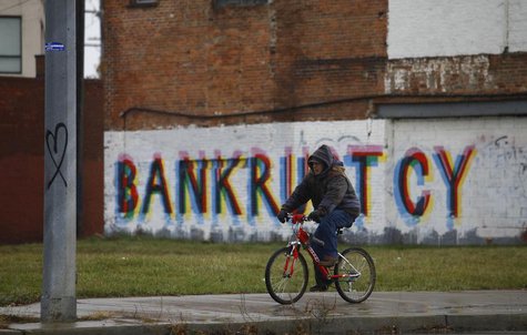 A man rides his bike past graffiti that reads "Bankruptcy" in Detroit, Michigan, December 3, 2013. REUTERS/Joshua Lott A man rides his bike past graffiti that reads "Bankruptcy" in Detroit, Michigan, December 3, 2013. REUTERS/Joshua Lott