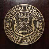 The Federal Deposit Insurance Corp (FDIC) logo is seen at the FDIC headquarters as Chairman Sheila Bair announces the bank and thrift indust The Federal Deposit Insurance Corp (FDIC) logo is seen at the FDIC headquarters as Chairman Sheila Bair announces the bank and thrift indust
