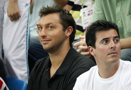Former world champion Ian Thorpe (L) of Australia watches the swimming events at the National Aquatics Centre during the 2008 Beijing Olympi Former world champion Ian Thorpe (L) of Australia watches the swimming events at the National Aquatics Centre during the 2008 Beijing Olympi