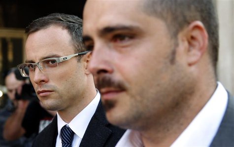 South African Olympic and Paralympic track star Oscar Pistorius (L) arrives to attend his trial at the high court in Pretoria April 8, 2014. South African Olympic and Paralympic track star Oscar Pistorius (L) arrives to attend his trial at the high court in Pretoria April 8, 2014.