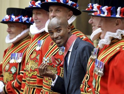 Britain's double Olympic champion Mo Farah poses with his Commander of the Order of the British Empire (CBE) medal, after being presented wi Britain's double Olympic champion Mo Farah poses with his Commander of the Order of the British Empire (CBE) medal, after being presented wi