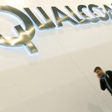 A man walks past a Qualcomm advertising logo at the Mobile World Congress at Barcelona, February 27, 2013. REUTERS/Albert Gea A man walks past a Qualcomm advertising logo at the Mobile World Congress at Barcelona, February 27, 2013. REUTERS/Albert Gea