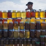 A vendor, who is also a beekeeper, sells honey at a road side market, some 170 kilometers (105 miles) north of Astana June 14, 2013. REUTERS A vendor, who is also a beekeeper, sells honey at a road side market, some 170 kilometers (105 miles) north of Astana June 14, 2013. REUTERS