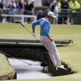 Sweden's Henrik Stenson jumps over the Swilcan Burn after chipping onto the first green during the final round of the British Open golf cham Sweden's Henrik Stenson jumps over the Swilcan Burn after chipping onto the first green during the final round of the British Open golf cham