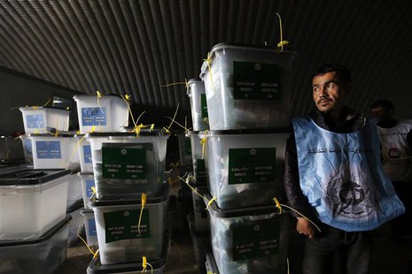 An Afghan election worker stands next to ballot boxes at a counting centre in Kabul April 6, 2014. REUTERS/Mohammad Ismail An Afghan election worker stands next to ballot boxes at a counting centre in Kabul April 6, 2014. REUTERS/Mohammad Ismail