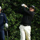 U.S. golfer Phil Mickelson (R) tees off on the fifth hole as compatript Dustin Johnson watches during a practice round ahead of the Masters U.S. golfer Phil Mickelson (R) tees off on the fifth hole as compatript Dustin Johnson watches during a practice round ahead of the Masters