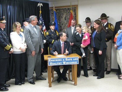 Gov. Scott Walker talking to Lillie Moe, who is Senator Julie Lassa's youngest daughter before signing part of the H.O.P.E. legislation. Also pictured: members of the Stevens Point Police Department and Portage County Sheriff's Department, Rep. John Nygren, Mayor Andrew Halverson, Rep. Amy Sue Vruwink Gov. Scott Walker talking to Lillie Moe, who is Senator Julie Lassa's youngest daughter before signing part of the H.O.P.E. legislation. Also pictured: members of the Stevens Point Police Department and Portage County Sheriff's Department, Rep. John Nygren, Mayor Andrew Halverson, Rep. Amy Sue Vruwink