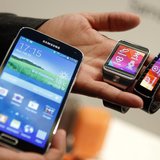 The new Samsung Galaxy S5 smartphone (L), Gear 2 smartwatch (C) and Gear Fit fitness band are displayed at the Mobile World Congress in Barc The new Samsung Galaxy S5 smartphone (L), Gear 2 smartwatch (C) and Gear Fit fitness band are displayed at the Mobile World Congress in Barc
