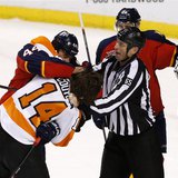 Apr 8, 2014; Sunrise, FL, USA; Linesman Pierre Racicot (65) tries to break up a fight between Florida Panthers defenseman Erik Gudbranson (4 Apr 8, 2014; Sunrise, FL, USA; Linesman Pierre Racicot (65) tries to break up a fight between Florida Panthers defenseman Erik Gudbranson (4