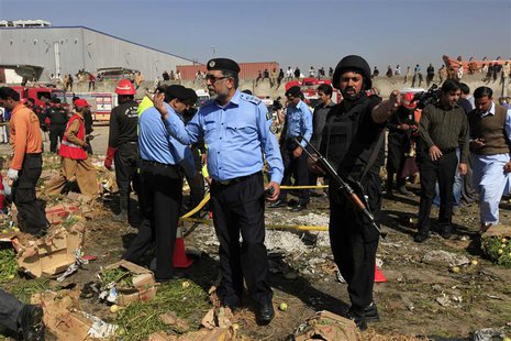Police officials and rescue workers gather at the site of a bomb blast in a vegetable and fruit market in Islamabad April 9, 2014. REUTERS/M Police officials and rescue workers gather at the site of a bomb blast in a vegetable and fruit market in Islamabad April 9, 2014. REUTERS/M